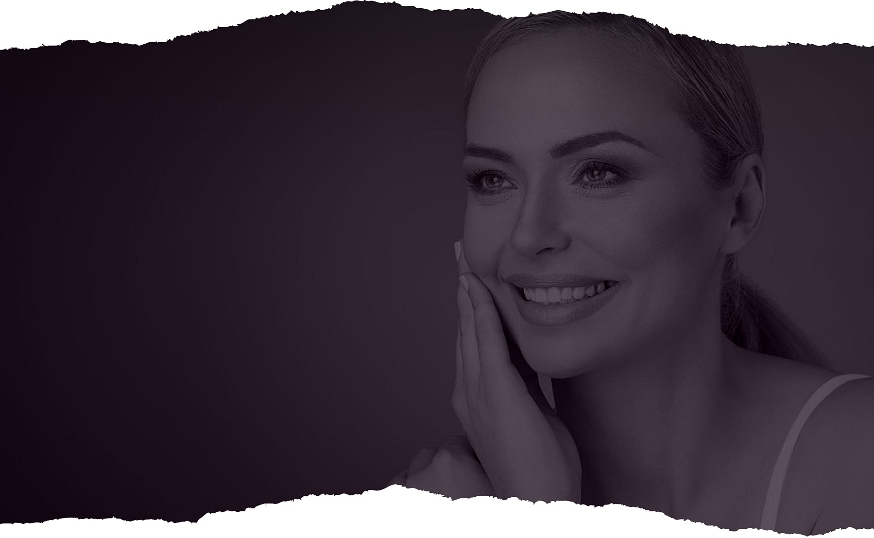 Woman smiling with hand on her face.