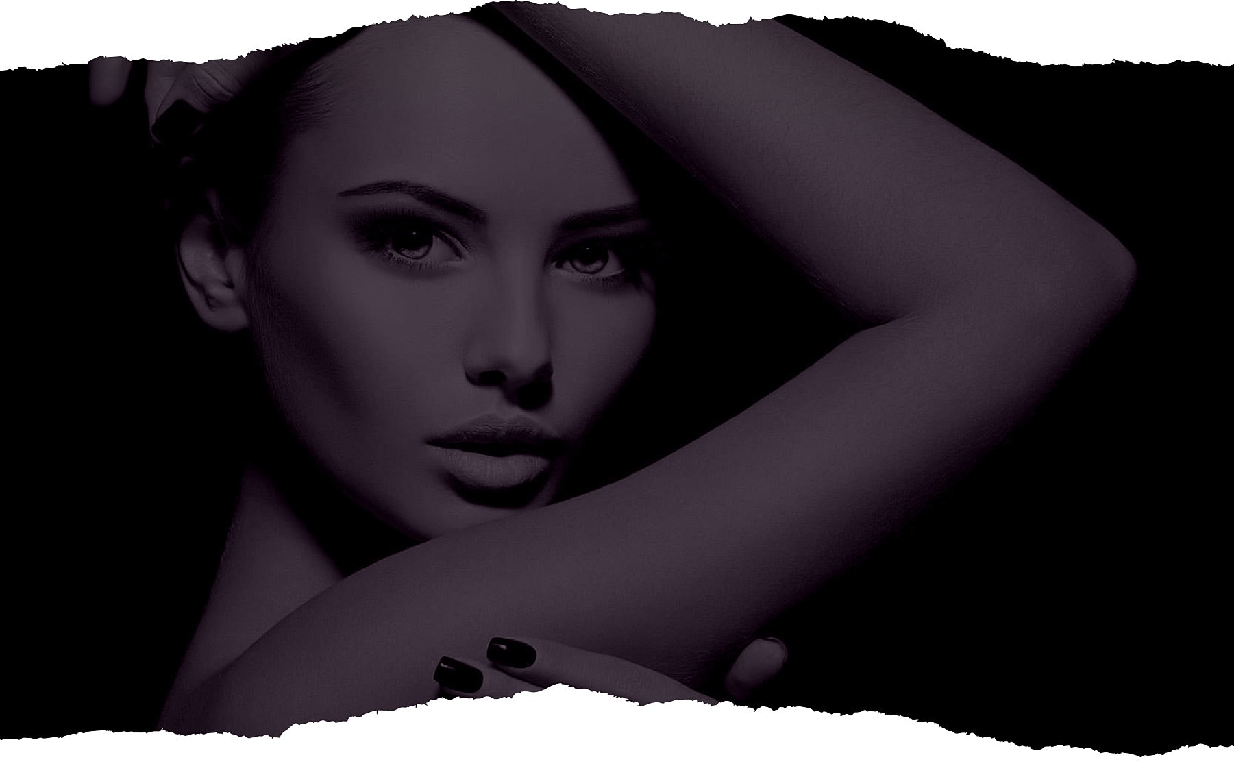 Dramatic portrait of a woman with dark backdrop.