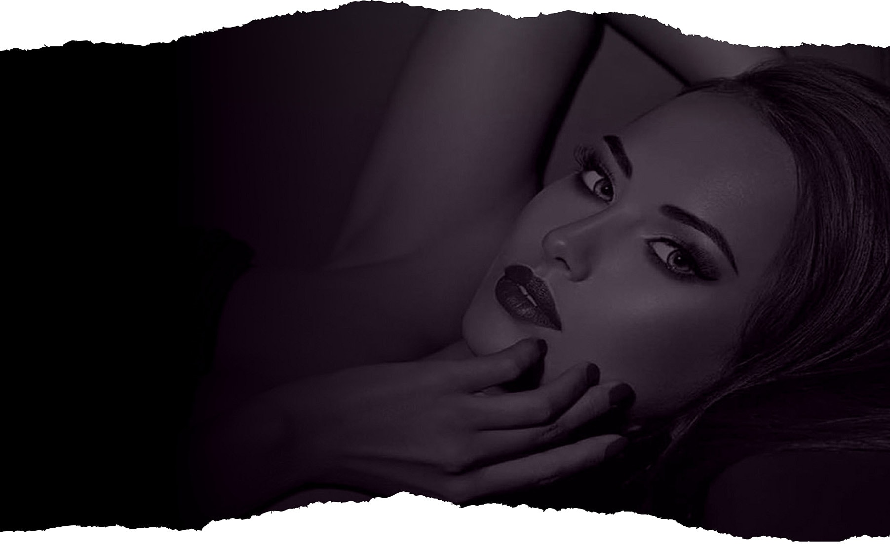 Woman with dark makeup on a textured background.