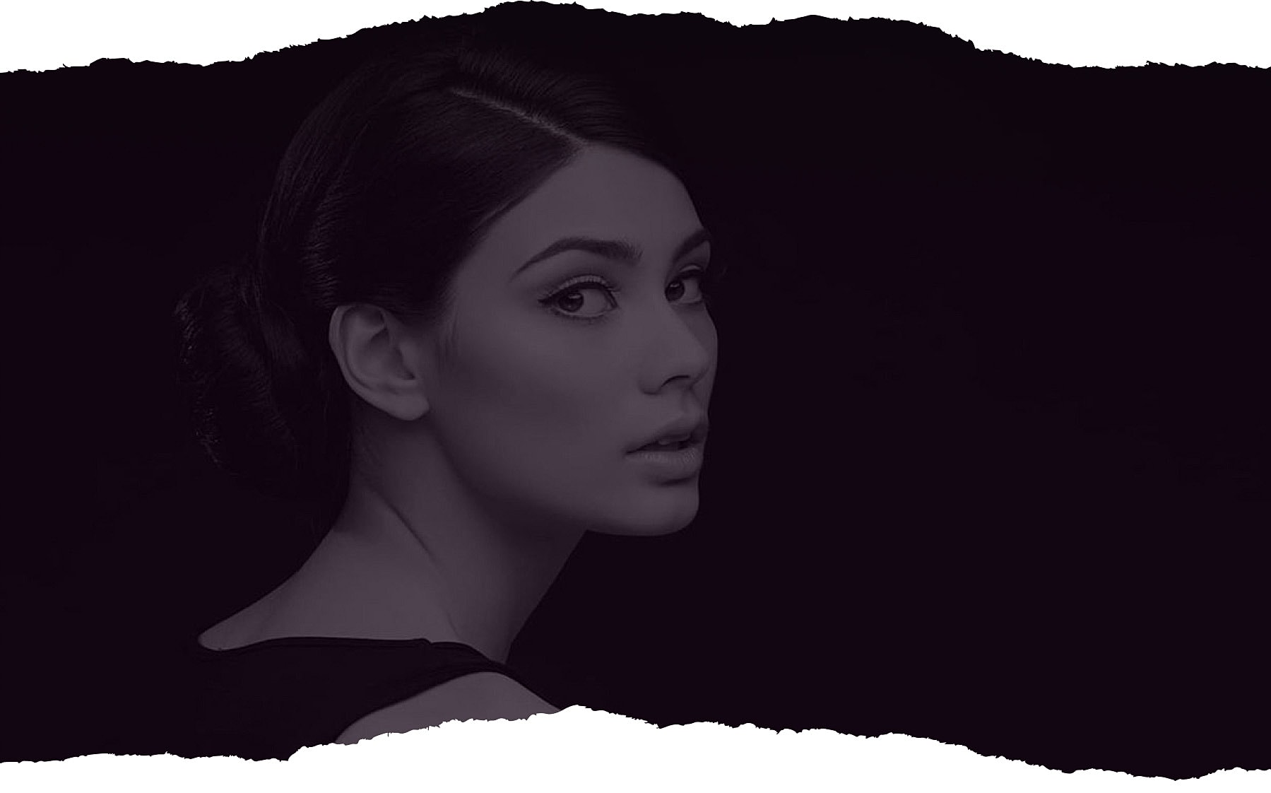 Woman in profile against dark background.