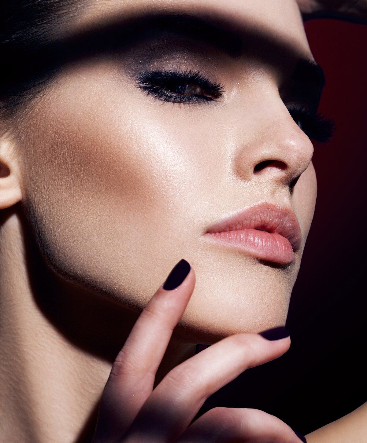 Close-up of a woman's face and hand.