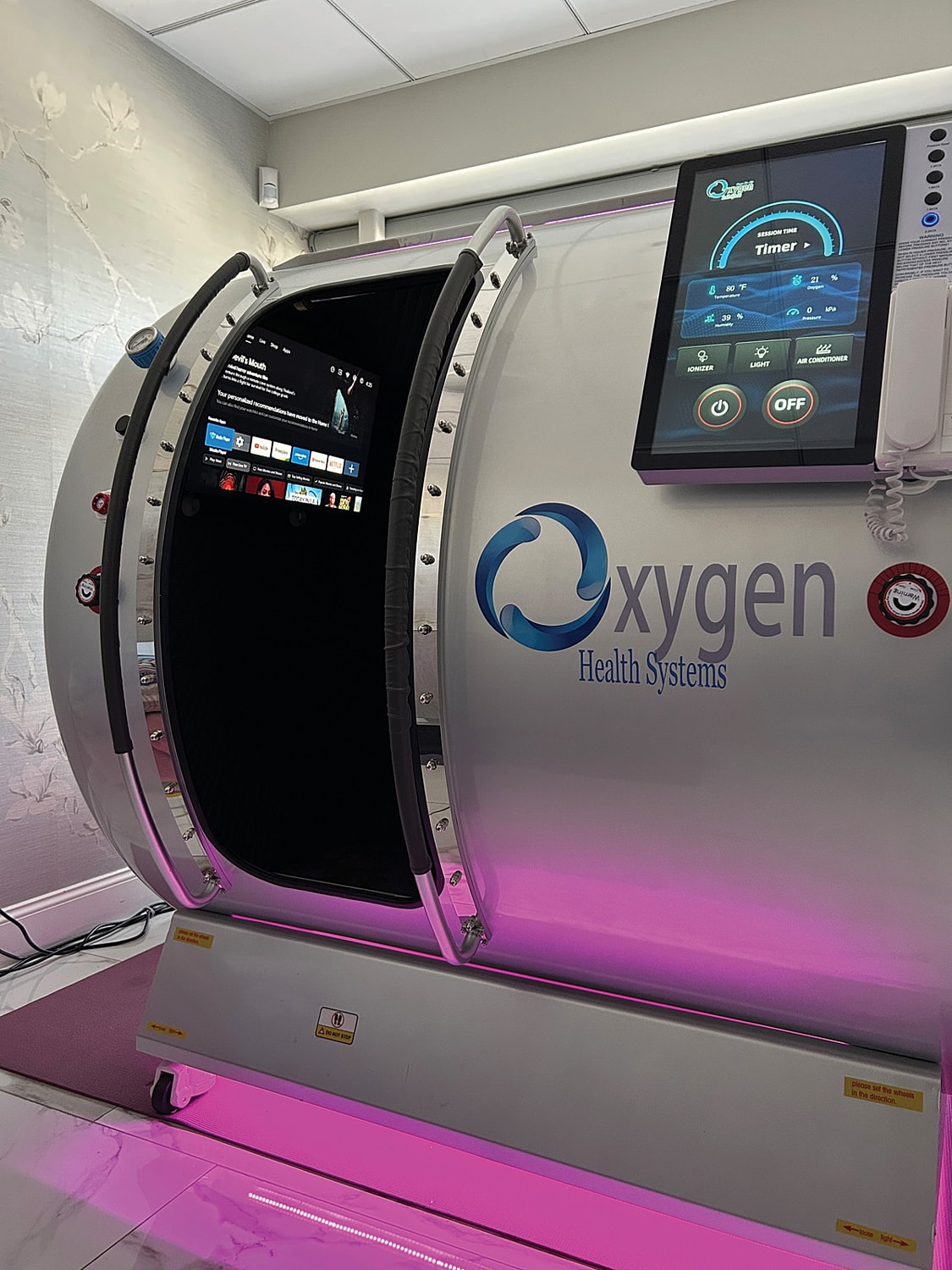 Hyperbaric oxygen therapy chamber with control panel.