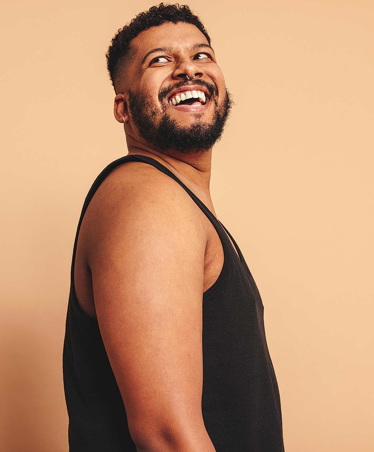Model posing in a sequined bikini by water.