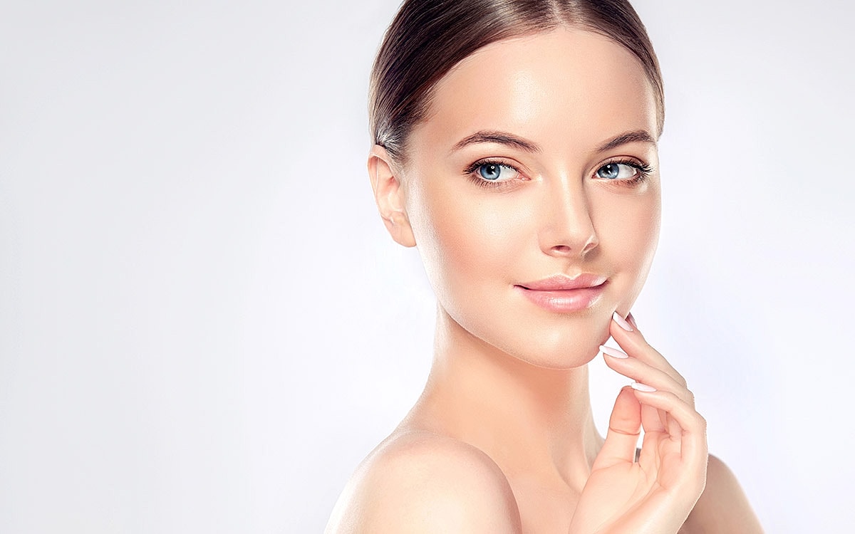 Woman with radiant skin and gentle smile.