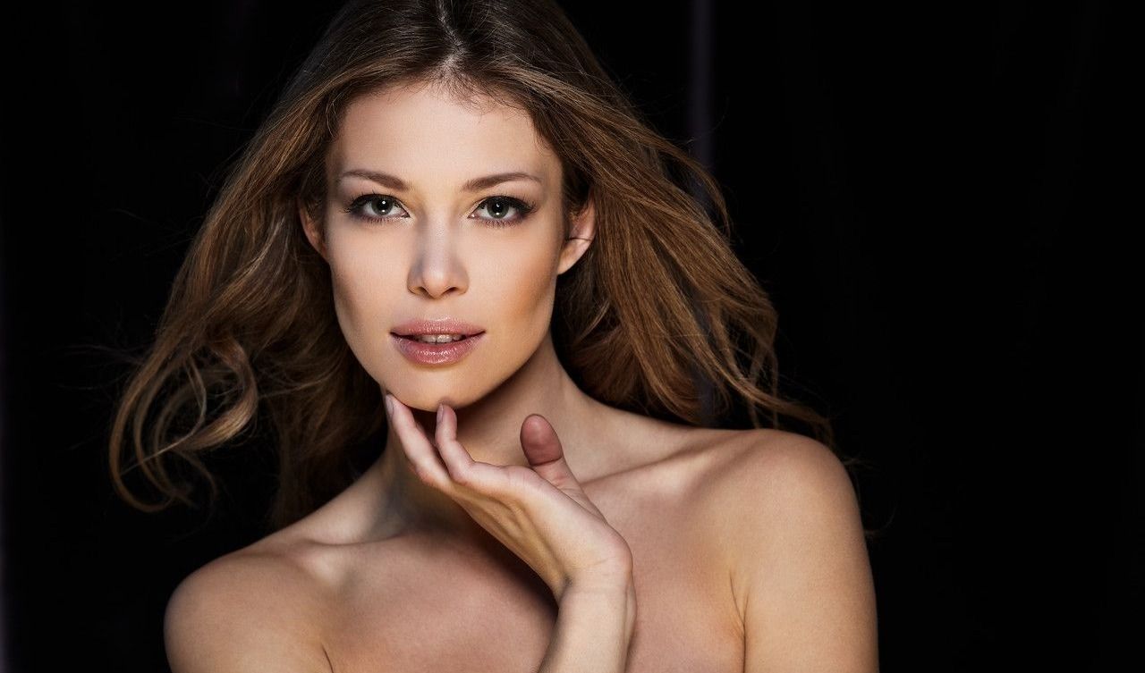 Woman with flowing hair and soft expression.