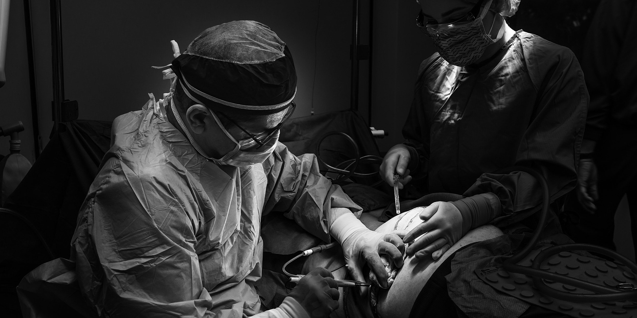 Surgeons performing a medical procedure in operating room.