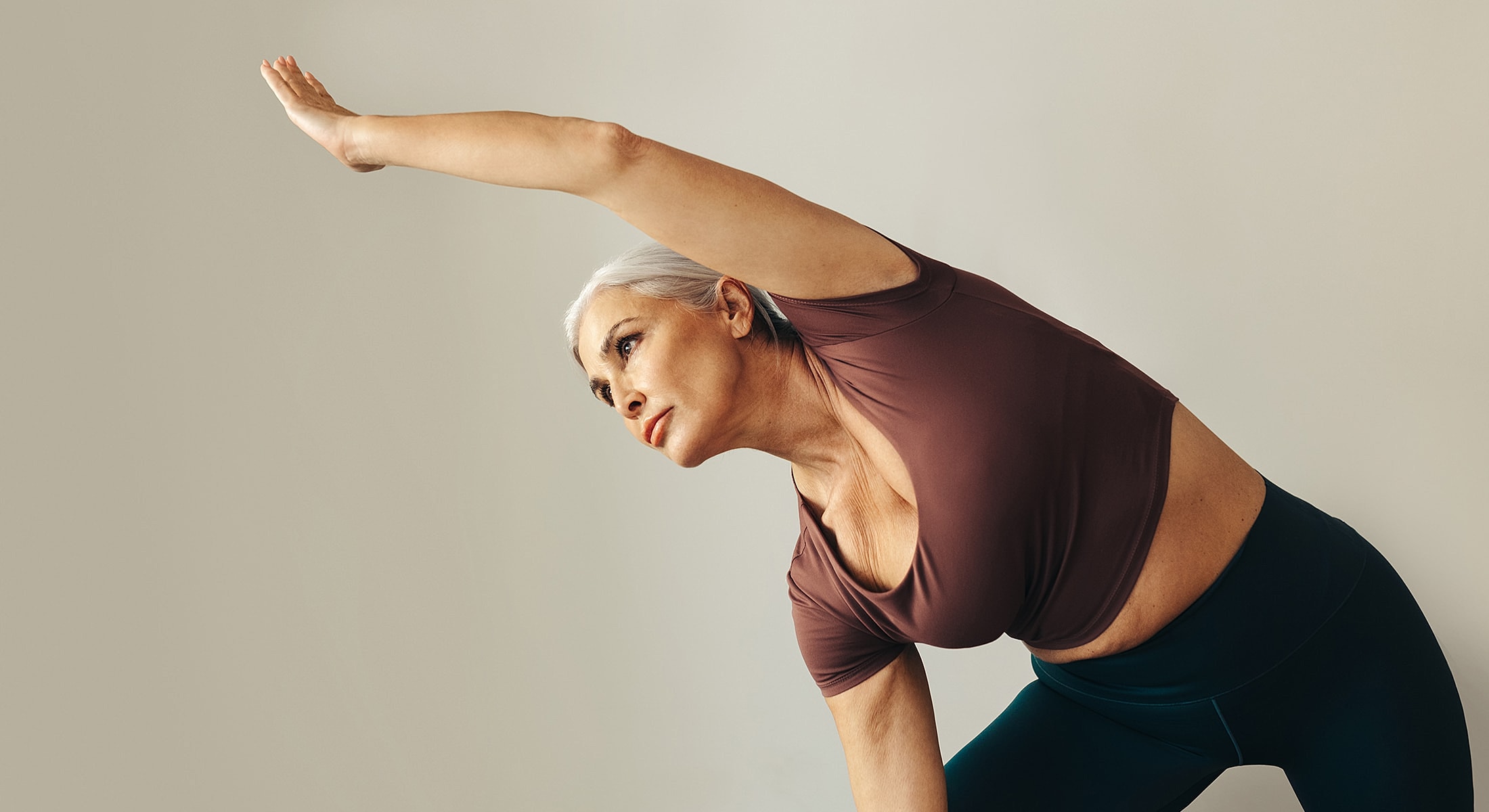 Senior woman practicing yoga in a studio.