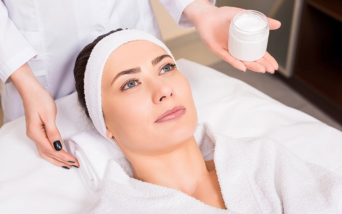 Woman receiving a skincare treatment in spa.