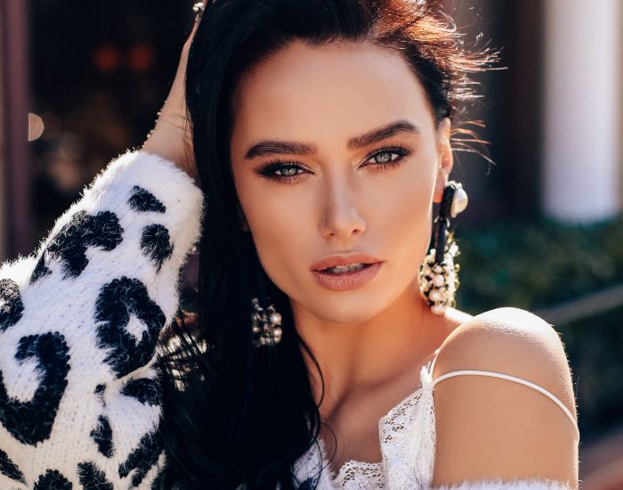 Woman with dark hair and stylish outfit.